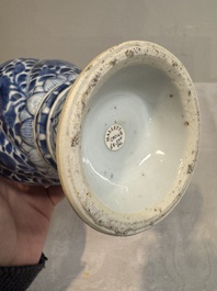 A pair of Chinese blue and white vases and covers with floral design, Kangxi