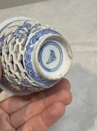 A pair of Chinese blue and white salts and a reticulated double-walled cup, Kangxi