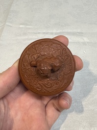 A Chinese Yixing stoneware 'phoenixes and peonies' teapot and cover, Kangxi