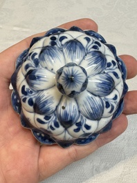 A pair of Chinese blue and white vases and covers with floral design, Kangxi