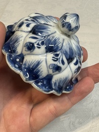 A pair of Chinese blue and white vases and covers with floral design, Kangxi