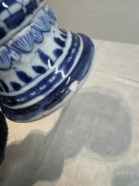 A pair of Chinese blue and white vases and covers with floral design, Kangxi