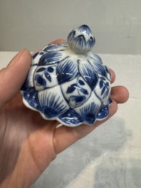 A pair of Chinese blue and white vases and covers with floral design, Kangxi