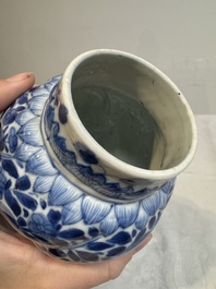 A pair of Chinese blue and white vases and covers with floral design, Kangxi