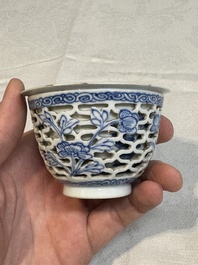 A pair of Chinese blue and white salts and a reticulated double-walled cup, Kangxi