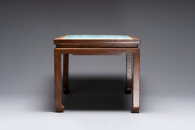 A Chinese famille rose turquoise-ground 'flower scrolls and bats' plaque, later mounted as table, Qianlong