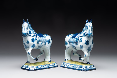 A fine pair of blue and white Dutch Delft horses on a green base, 18th C.