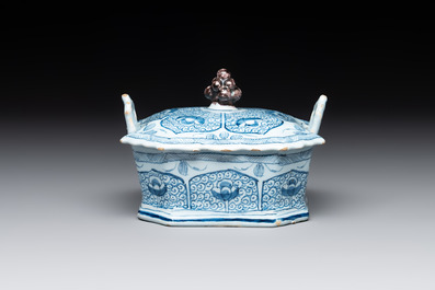 A blue and white Dutch Delft butter tub and cover with a berry finial, 18th C.