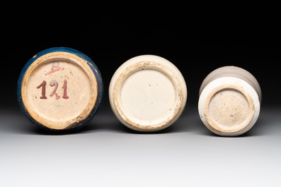 A blue-glazed albarello and two white-glazed albarelli, Spain, 17th C.
