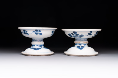 A pair of Chinese blue and white salts and a reticulated double-walled cup, Kangxi