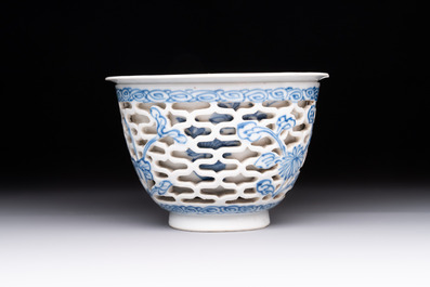 A pair of Chinese blue and white salts and a reticulated double-walled cup, Kangxi