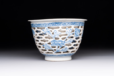 A pair of Chinese blue and white salts and a reticulated double-walled cup, Kangxi