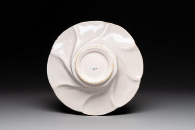 A polychrome Dutch Delft twisted 'Queen Mary' dish, erroneously inscribed K N, 17th C.
