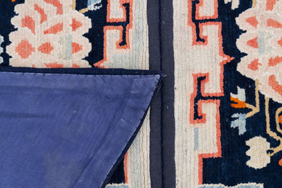 Two Tibetan saddle rugs with Buddhist lions and antiquities, 19th C.