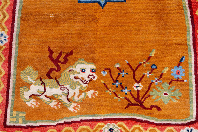 Two Tibetan saddle rugs with Buddhist lions and antiquities, 19th C.