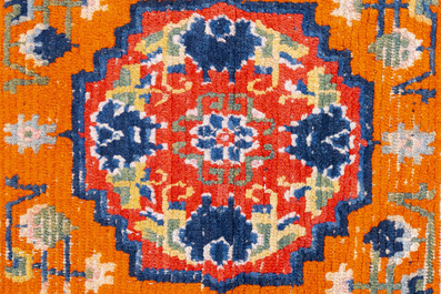 Two Tibetan saddle rugs and three small rugs, 19th C.