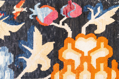 A pair of Tibetan woollen rugs with floral design, 19th C.