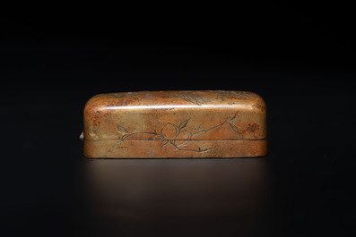 Four Chinese white and spinach-green jade archer rings and a bronze box with a crane design, 19th C.