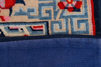 Two Tibetan saddle rugs and three small rugs, 19th C.