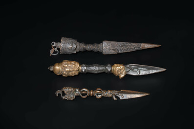 Four Tibetan bronze and wooden phurbas, a 'kapala' or skull-bowl and two silver ornaments, 19th C.