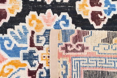 Two Tibetan woollen rugs with floral design, 19th C.