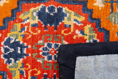 Two Tibetan saddle rugs and three small rugs, 19th C.