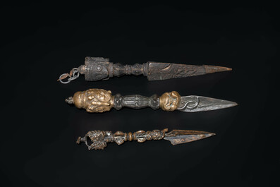 Four Tibetan bronze and wooden phurbas, a 'kapala' or skull-bowl and two silver ornaments, 19th C.