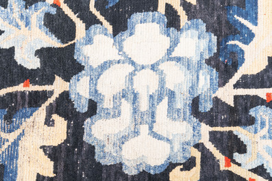 A pair of Tibetan woollen rugs with floral design, 19th C.