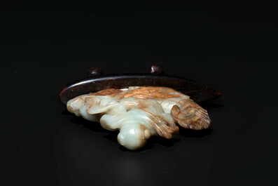 A Chinese celadon and russet jade figure of a boy riding a dragon carp, Qing