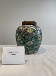 A Chinese verte biscuit 'lotus scroll' jar with wooden cover, Qing