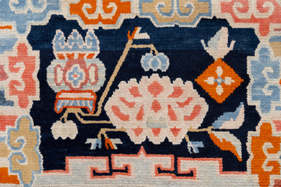 Two Tibetan saddle rugs with Buddhist lions and antiquities, 19th C.