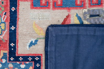 Two Tibetan saddle rugs with floral design, 19th C.