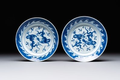 A pair of Chinese blue and white 'dragon' plates and a plate with narrative design, Yuzhen mark, Kangxi/Yongzheng