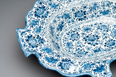 A very rare and large blue and white Dutch Delft double barber's bowl with floral design, late 17th C.