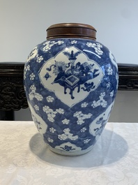 A Chinese blue and white 'prunus on cracked ice' jar with wooden cover, 19th C.