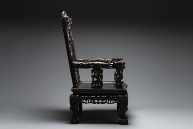 A richly carved Chinese lacquered hongmu armchair, Canton, 19th C.