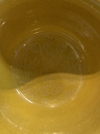 A Chinese yellow-glazed 'anhua' 'carp and lotus' bowl, Kangxi mark, 19th C.