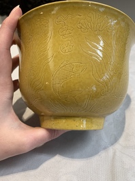 A Chinese yellow-glazed 'anhua' 'carp and lotus' bowl, Kangxi mark, 19th C.