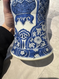 A pair of Chinese blue and white 'gu' vases with floral design, Kangxi