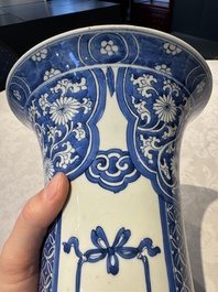 A pair of Chinese blue and white 'gu' vases with floral design, Kangxi