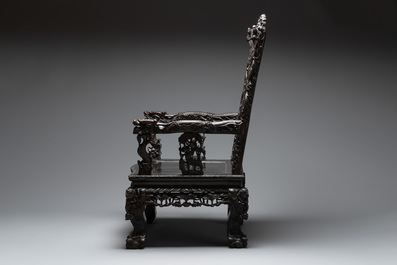 A richly carved Chinese lacquered hongmu armchair, Canton, 19th C.