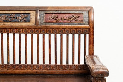 A Chinese carved and lacquered wooden bench, 19th C.