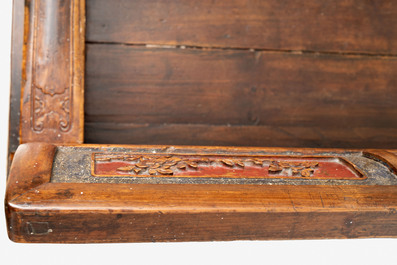A Chinese carved and lacquered wooden bench, 19th C.