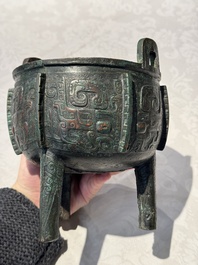 A Chinese archaic bronze tripod food vessel with 'taotie' design, 'ding 鼎', Western Zhou