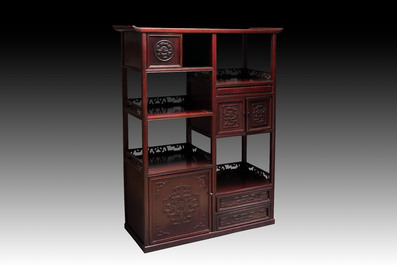 A Chinese carved wooden cabinet with chilong design, 20th C.