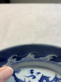 A pair of Chinese blue and white 'dragon' plates and a plate with narrative design, Yuzhen mark, Kangxi/Yongzheng