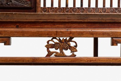 A Chinese carved and lacquered wooden bench, 19th C.
