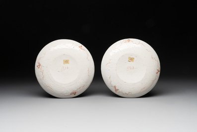 A pair of polychrome Dutch Delft dor&eacute; armorial plates, dated 1728