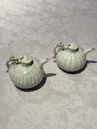 A pair of Chinese qingbai ewers and covers with dragon-form handles, Song/Yuan