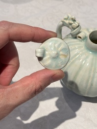 A pair of Chinese qingbai ewers and covers with dragon-form handles, Song/Yuan